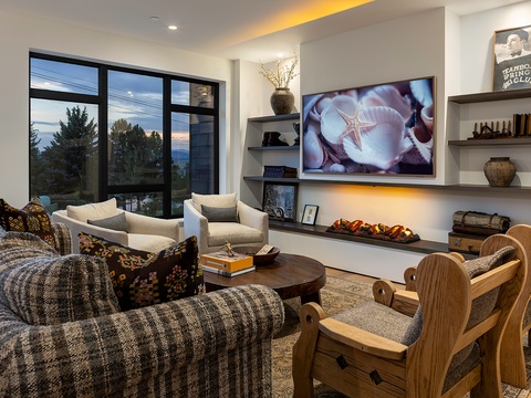 Sink into plush seating and unwind in your thoughtfully designed living space, where expansive windows frame stunning mountain views and modern touches create the perfect retreat after your adventures.