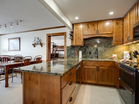 Cook together in your spacious kitchen with granite countertops and warm wood cabinetry, then gather around the island's breakfast bar to share meals and make memories.