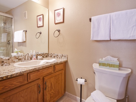 Your private bathroom features a stylish mosaic-tiled vanity, plush towels, and a refreshing walk-in shower—perfectly designed for your comfort and convenience.