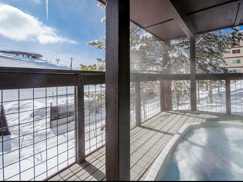 Snowy mountain views surround this private hot tub on your covered balcony—perfect for soaking after a day on the slopes. Sip something warm and watch icicles catch the sunlight overhead.