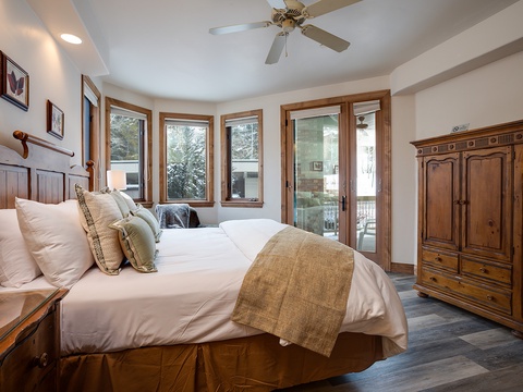 Wake up wrapped in crisp linens with mountain views from your windows and balcony door, where snowy pines frame your retreat in natural beauty.