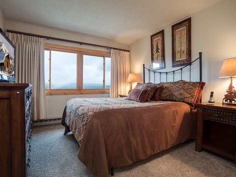 Drift off in comfort with mountain views stretching beyond your window. Warm wood furnishings and soft bedding create your cozy retreat after a day of adventure.