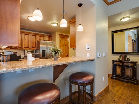 Step into a welcoming kitchen designed for gathering and creating memories. Gleaming granite countertops and rich wood cabinetry invite you to prepare your favorite meals in this well-appointed space.