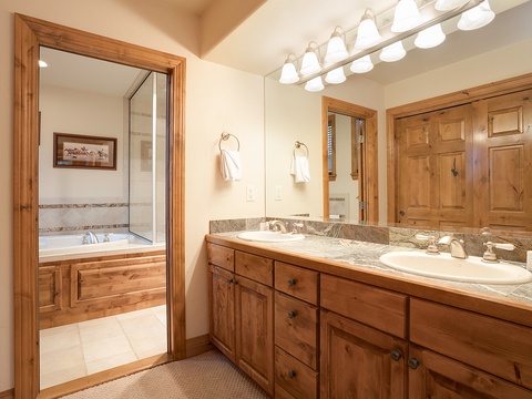 Unwind in your private bathroom, where warm wood tones and polished granite surfaces create a spa-like retreat perfect for refreshing mornings and relaxing evenings.