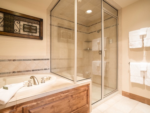 Slip into your private soaking tub or refresh in the elegant glass-enclosed shower. Fluffy towels wait for you in your bright, beautifully appointed bathroom.