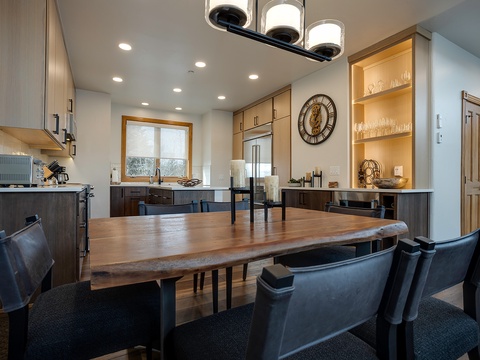 Gather around this welcoming dining table where you'll savor home-cooked meals in your fully-equipped modern kitchen, complete with gleaming counters, stylish cabinetry, and all the amenities you need to feel at home.