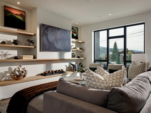 Sink into plush seating and enjoy mountain views framed by expansive windows. Your living room invites relaxation with its cozy fireplace and thoughtful design touches.