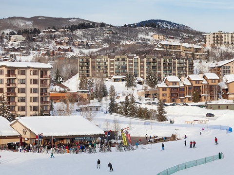 A vibrant ski resort village nestled in snow-covered mountains, offering winter vacation accommodations and direct access to slopes and alpine activities.