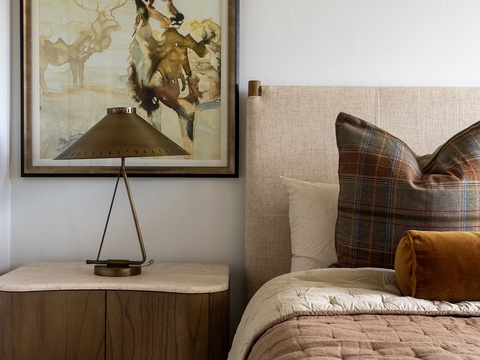 Curl up in this cozy bedroom where rustic mountain charm meets comfort—your restful retreat awaits with inviting linens and warm touches.