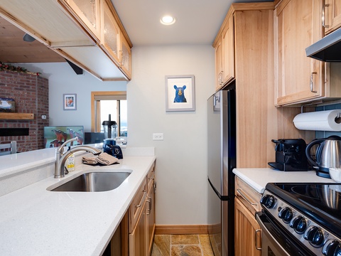 Your fully equipped kitchen invites easy meal prep with sleek countertops, modern appliances, and warm wood cabinetry—everything you need to cook and gather comfortably during your stay.