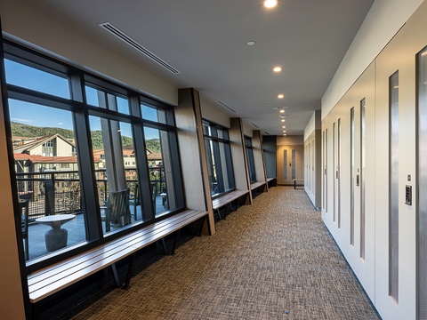 Your home base features a bright corridor with scenic mountain views through floor-to-ceiling windows, plus convenient elevator access to whisk you to your room. Inviting window benches let you linger and soak in the hillside surroundings.