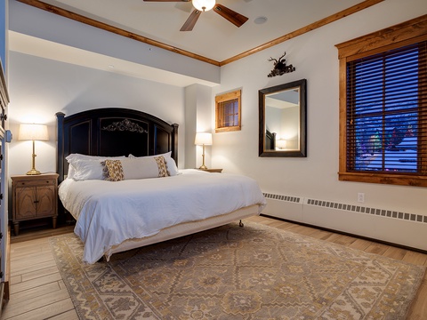 Sink into your plush bed with crisp linens and rustic mountain charm. Wood beams and warm lighting create a cozy retreat for restful nights after your adventures.