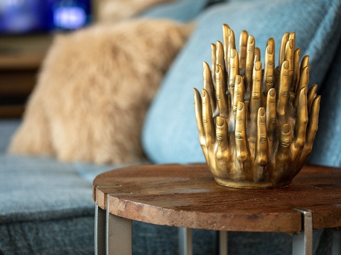 Unique golden sculpture and cozy textures welcome you to this thoughtfully styled living space, where every detail creates a warm, inviting retreat.