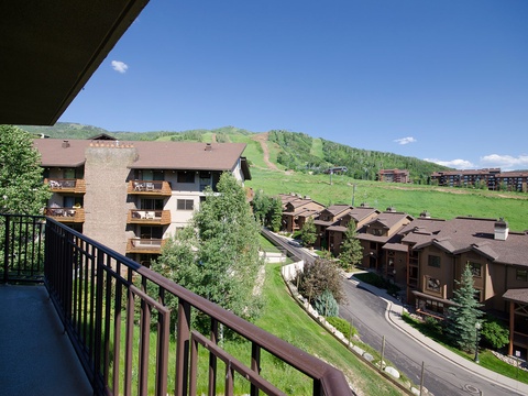 Mountain resort setting with ski slopes and neighboring properties visible from the surrounding area, showcasing the property's alpine location and scenic hillside neighborhood.
