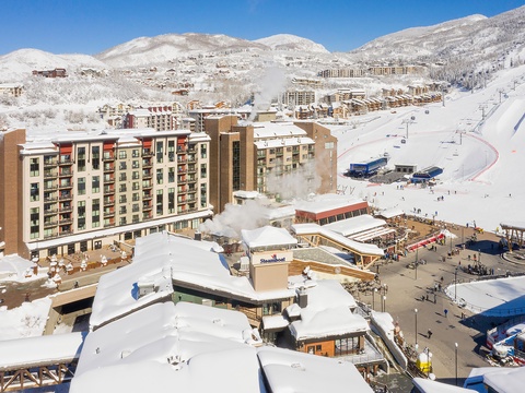 Nestled in a pristine mountain valley, this winter resort offers direct access to world-class skiing, cozy alpine lodging, and vibrant village amenities all blanketed in fresh snow.