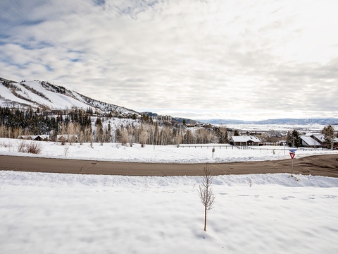Snow-covered mountain slopes and valley landscape frame this quiet winter neighborhood, offering serene seasonal beauty near the property.