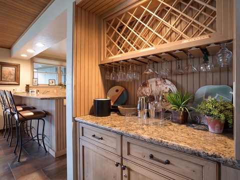 Your private wine bar awaits, complete with elegant glass storage, granite counters, and thoughtful touches that set the stage for memorable evenings.
