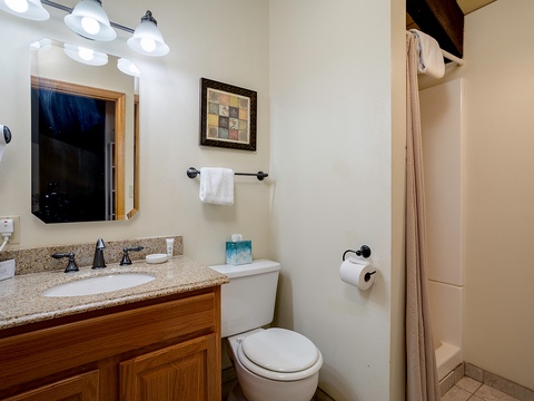 Your private bathroom features a granite vanity, fresh linens, and a cozy tiled shower—a peaceful retreat after a day of exploring.
