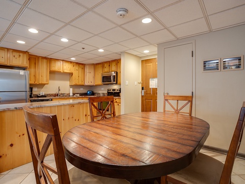 Your fully equipped kitchen features warm knotty pine cabinetry, granite countertops, and stainless appliances—perfect for preparing meals at your leisure. Gather at the rustic dining table and enjoy home-cooked comfort during your stay.