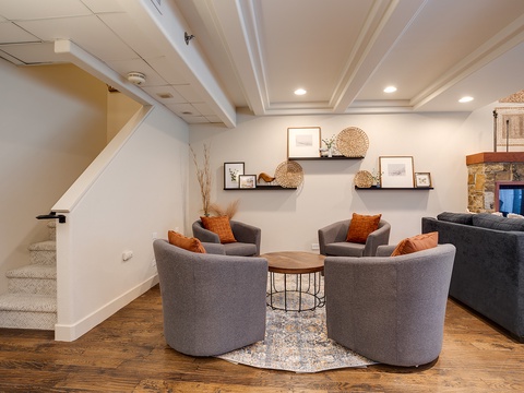 Gather with your group in this inviting lower-level lounge with cozy seating, warm accent pillows, and a beautiful stone fireplace—perfect for relaxed conversation and unwinding together.