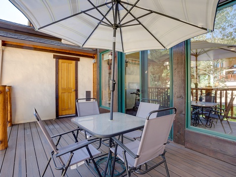 Your private patio offers a shaded dining space perfect for morning coffee or al fresco meals, surrounded by peaceful tree views and fresh mountain air.