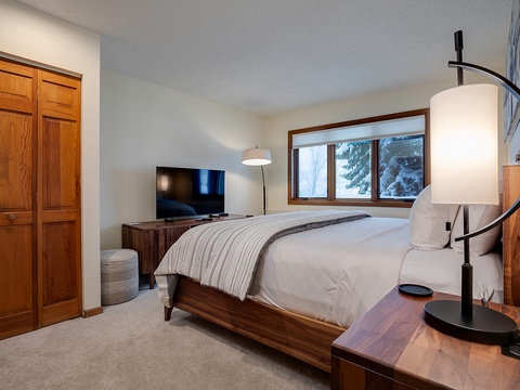 Unwind in your private bedroom with modern comforts and serene mountain views. Plush bedding, rich wood tones, and natural light create the perfect retreat after a day of exploring.