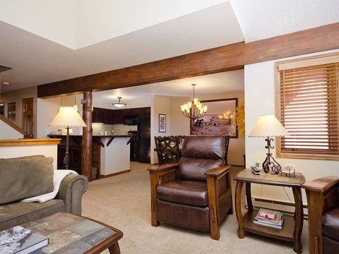 Unwind in your cozy mountain retreat with leather recliners, warm wood beams, and a fully-equipped kitchen ready for your stay.
