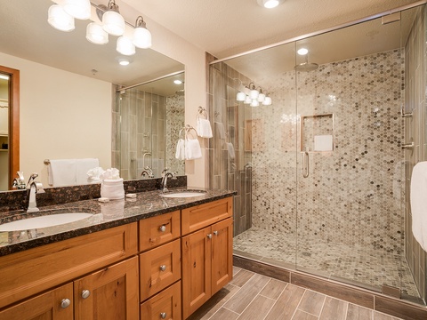 Step into your spa-like bathroom with its spacious walk-in shower, elegant penny-tile accents, and dual vanity perfect for getting ready for the day.