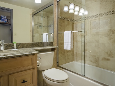 Step into your beautifully tiled bathroom, where a spacious tub-shower combo and elegant finishes create a serene retreat after your day exploring.