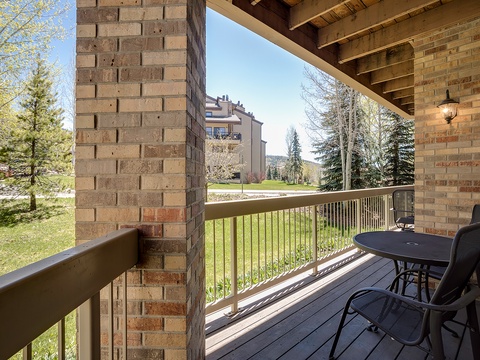 Your private balcony opens to a serene view of green lawns, mature trees, and mountain-framed horizons, offering a quiet spot to savor morning coffee or unwind after a day exploring.