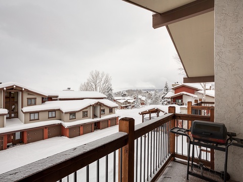 A snow-dusted alpine village stretches before you, with mountain chalets nestled among evergreens. Your balcony offers a private perch to savor the winter wonderland, complete with a BBQ for cozy outdoor meals.