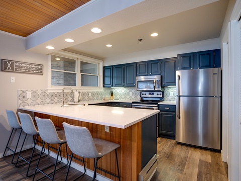 Gather around your well-equipped island kitchen, perfect for preparing meals and sharing stories. Modern appliances and a spacious layout make every cooking experience effortless.