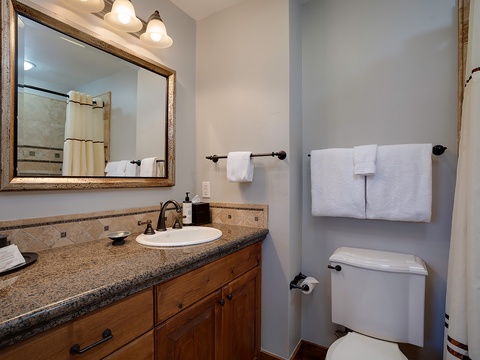 Refresh in your elegantly appointed bathroom with granite counters, warm wood cabinetry, soft towels, and a relaxing shower awaiting your arrival.