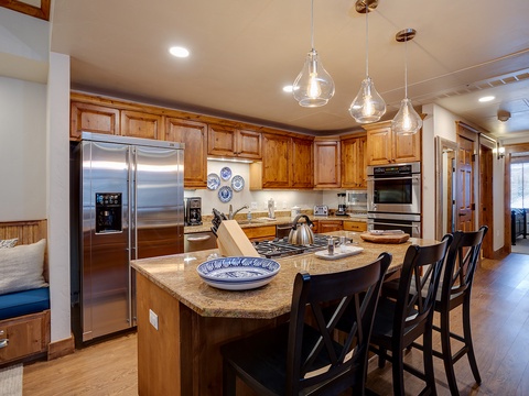 Gather around this spacious island with modern appliances at your fingertips. Enjoy warm wood cabinetry, granite countertops, and everything you need to whip up delicious meals together.