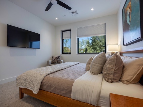 Relax in your bright, airy bedroom with a plush bed and fresh linens. The ceiling fan and crisp natural light make it a perfect retreat after a day of exploring.