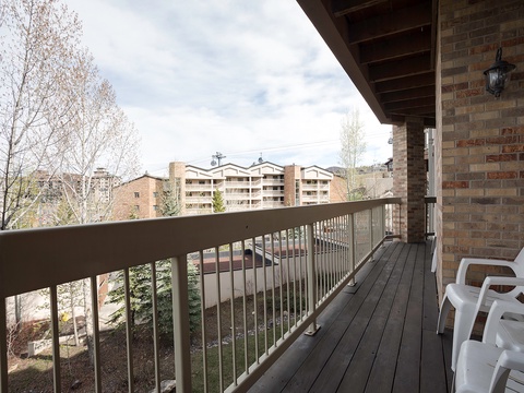 A private balcony overlooking a peaceful mountain town, offering the perfect spot to sip your morning coffee and enjoy fresh alpine air during your stay.