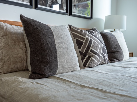 Sink into plush pillows and soft linens in your peaceful bedroom retreat, where stylish textures and soothing tones create the perfect space for rest and relaxation.