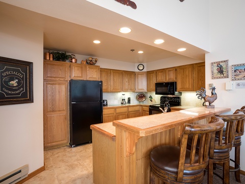 Your fully equipped kitchen features oak cabinetry, granite countertops, and a welcoming breakfast bar where you can start your mornings or share meals together.