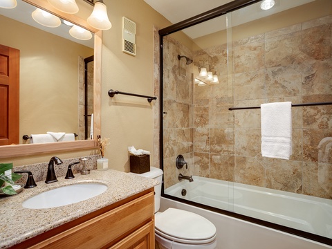 Step into your private spa-like bathroom with elegant tile work, a soaking tub, and rainfall shower. Fresh towels and warm lighting welcome you home after each adventure.