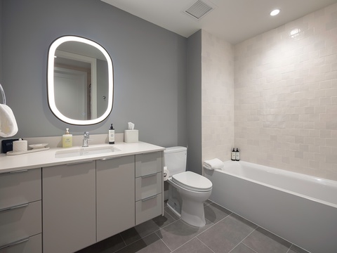Refresh in your modern spa-like bathroom, complete with a soaking tub, sleek vanity, and soft lighting for ultimate relaxation.