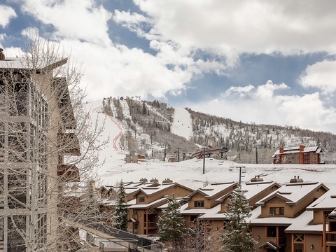 Ski-in/ski-out mountain village nestled beneath pristine slopes, offering direct access to winter adventures amid snow-covered peaks and alpine charm.