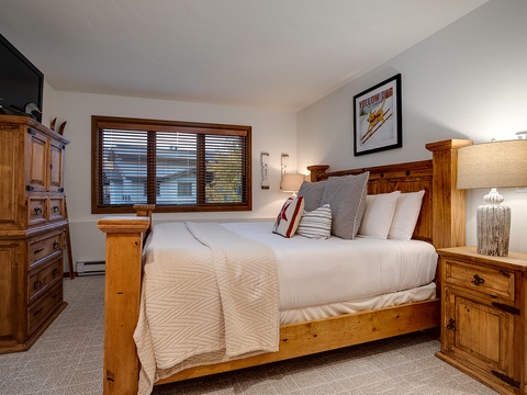 Your cozy retreat awaits with a plush bed, warm wood furnishings, and mountain-inspired décor to help you unwind after a day of adventure.