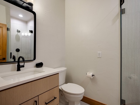 Unwind in your private bathroom featuring modern fixtures, a walk-in shower, and sleek black accents that bring contemporary style to your daily routine.