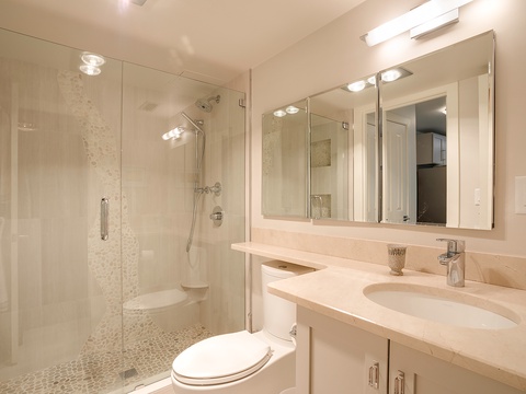Step into your beautifully updated bathroom with elegant marble counters, dual sinks, and a spa-like walk-in shower with pebble flooring. Everything you need to feel refreshed.