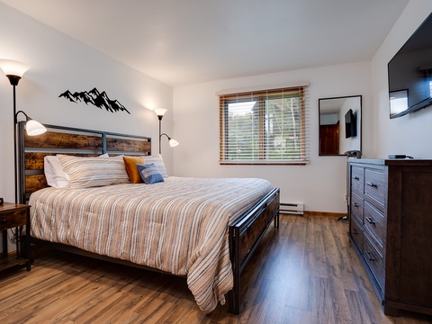 Sink into this cozy bed after a day of adventure, with warm wood tones, soft linens, and a mountain-inspired retreat that's all yours to enjoy.