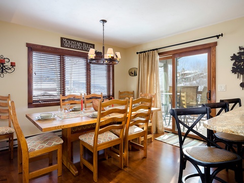 Gather around the dining table for a meal with mountain views framing your stay. Natural light and cozy touches create the perfect spot for your group to connect.
