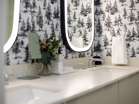 Fresh florals and chic ski-themed wallpaper make this bathroom your stylish mountain retreat after a day of adventure.