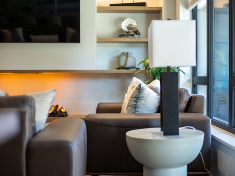 Sink into plush seating beside your glowing fireplace, where soft textures and warm ambient lighting create the perfect spot to unwind after exploring the area.