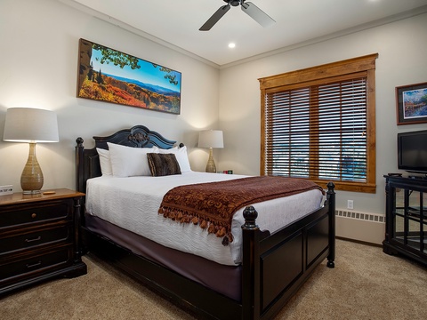 Sink into crisp linens and let the mountain vistas on the walls carry you away. Your cozy retreat features warm lighting, elegant furnishings, and all the comforts for a restful night.