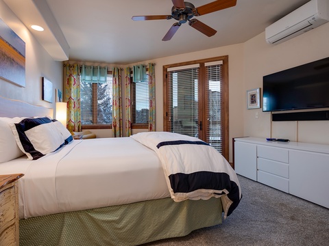 Sink into crisp linens and unwind in your serene bedroom, where a plush bed, soothing accents, and modern amenities create your perfect retreat after a day of adventure.